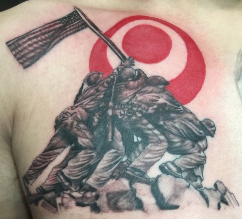 Tattoo depicting the raising of the flag at Iwo Jima with a red circle in the background.