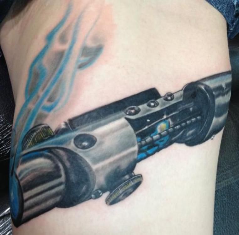 Tattoo of a metallic lightsaber, blue smoke rising from it.