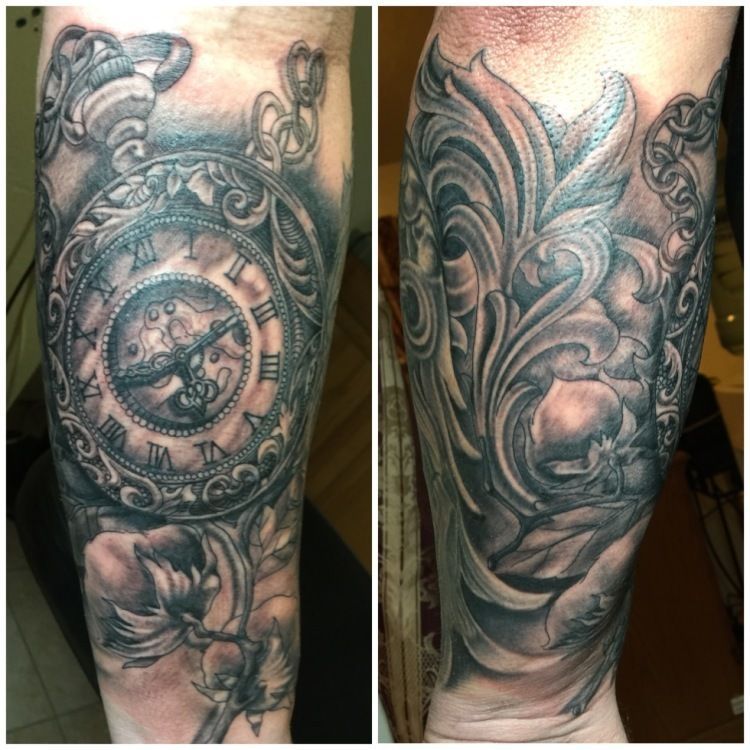 Tattoo of a pocket watch and ornate floral design on an arm in black and gray ink.