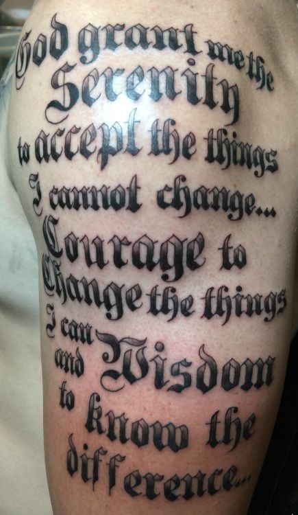 Tattoo on an arm: Serenity Prayer in gothic font.