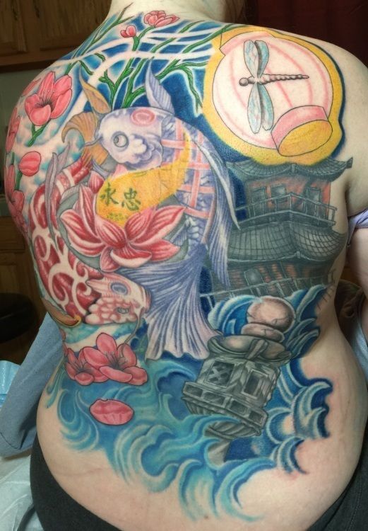 Full back tattoo featuring koi fish, lotus flowers, Japanese pagoda, and dragonfly. 