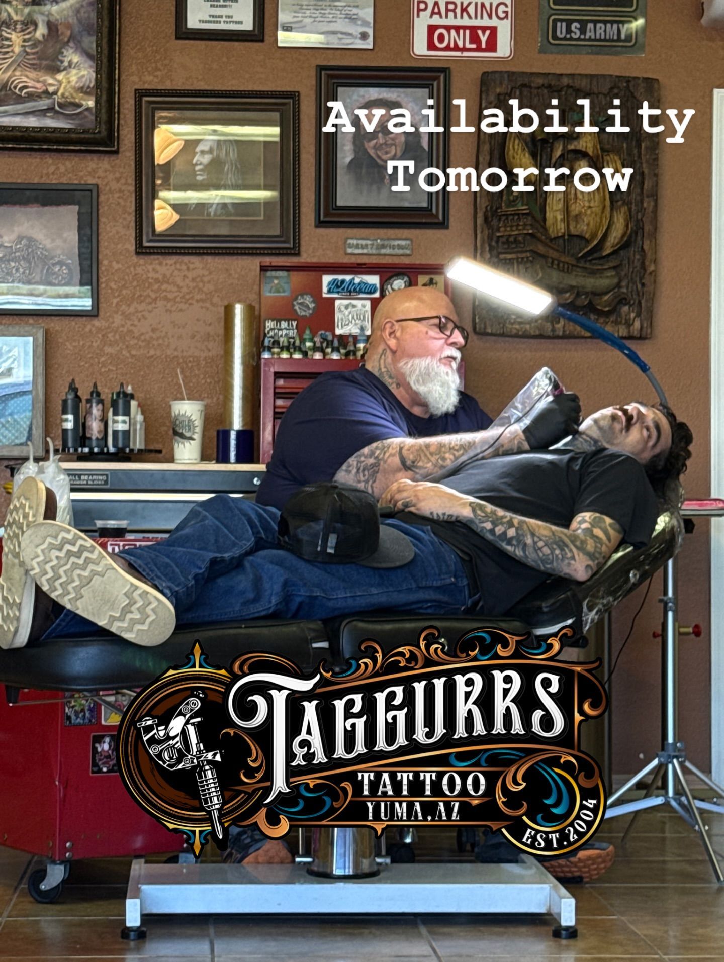 Tattoo artist tattooing a client's arm. Shop interior with 