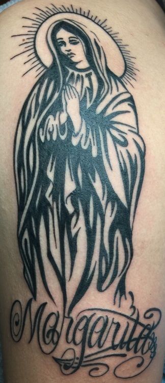 Tattoo of the Virgin Mary with a halo and the name 