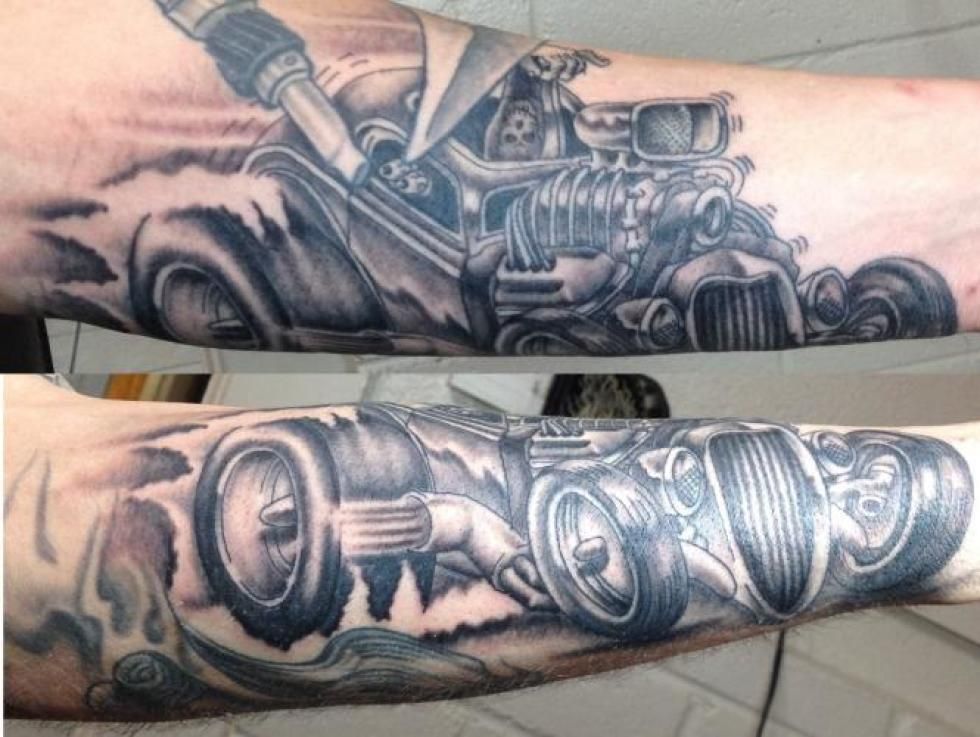 Black and gray tattoo of a hot rod car on arm.