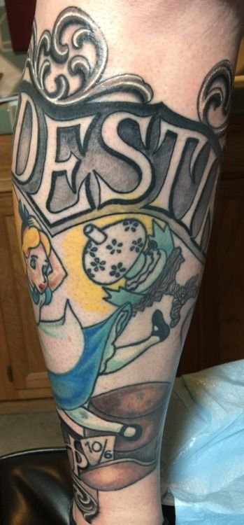 Alice in Wonderland tattoo on a leg: Hatter, Alice, and banner with 