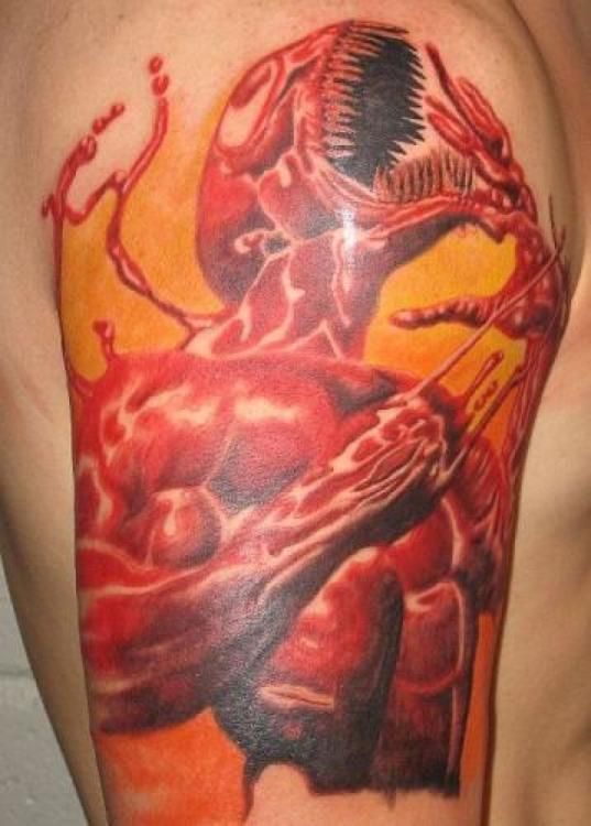 Carnage tattoo on upper arm, red and black, orange background.
