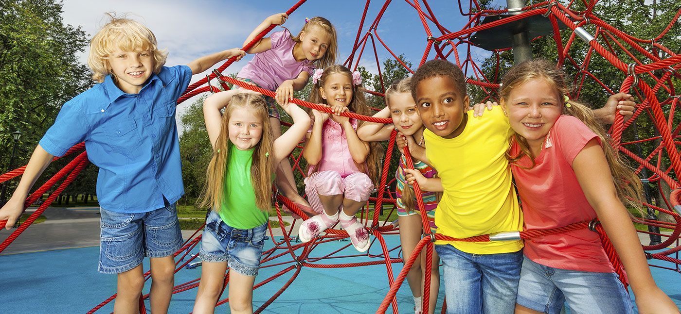 A group of children are playing on a jungle gym