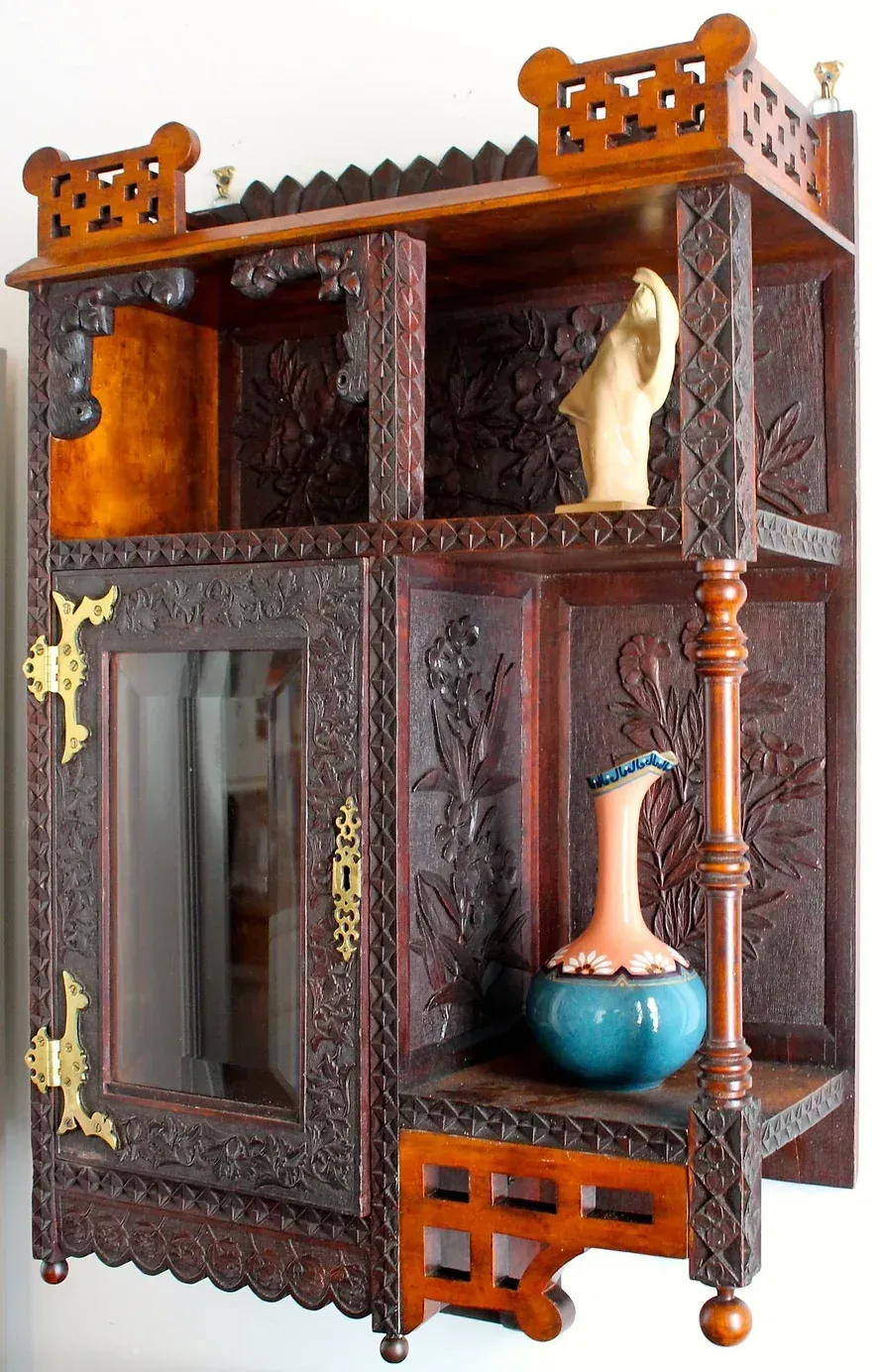 A wooden shelf with a vase on top of it