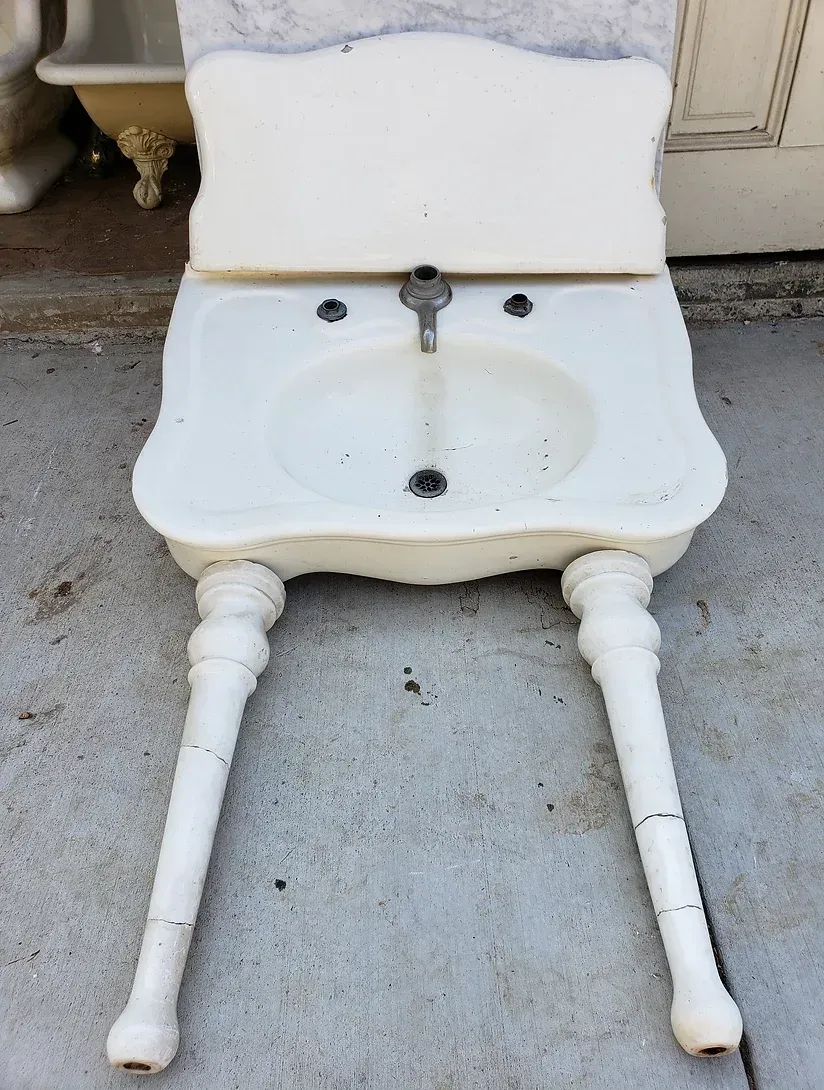 A white toilet with a sink attached to it