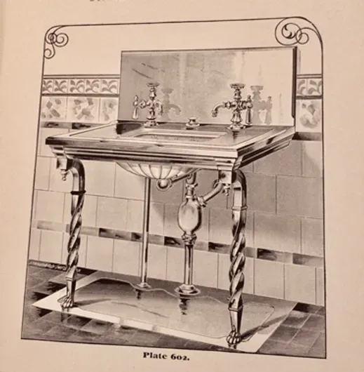 A black and white photo of a sink with the word plate on the bottom