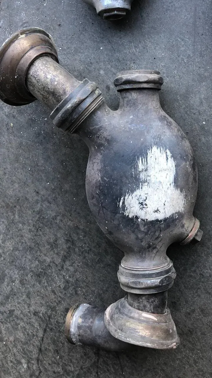 A close up of a metal pipe on a concrete surface.