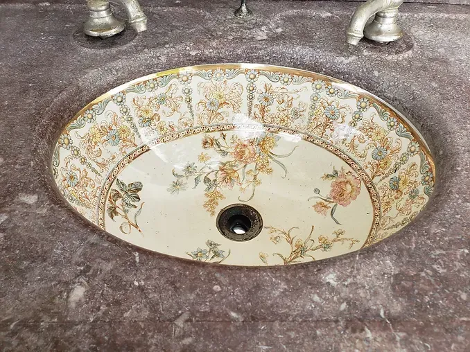 A bathroom sink with a floral design on it