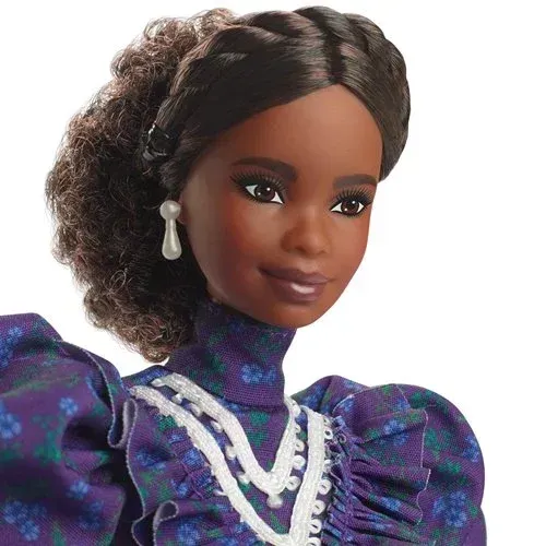 A close up of a barbie doll wearing a purple dress and earrings.