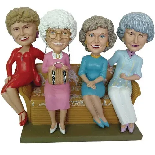 Four figurines of older women are sitting on a couch