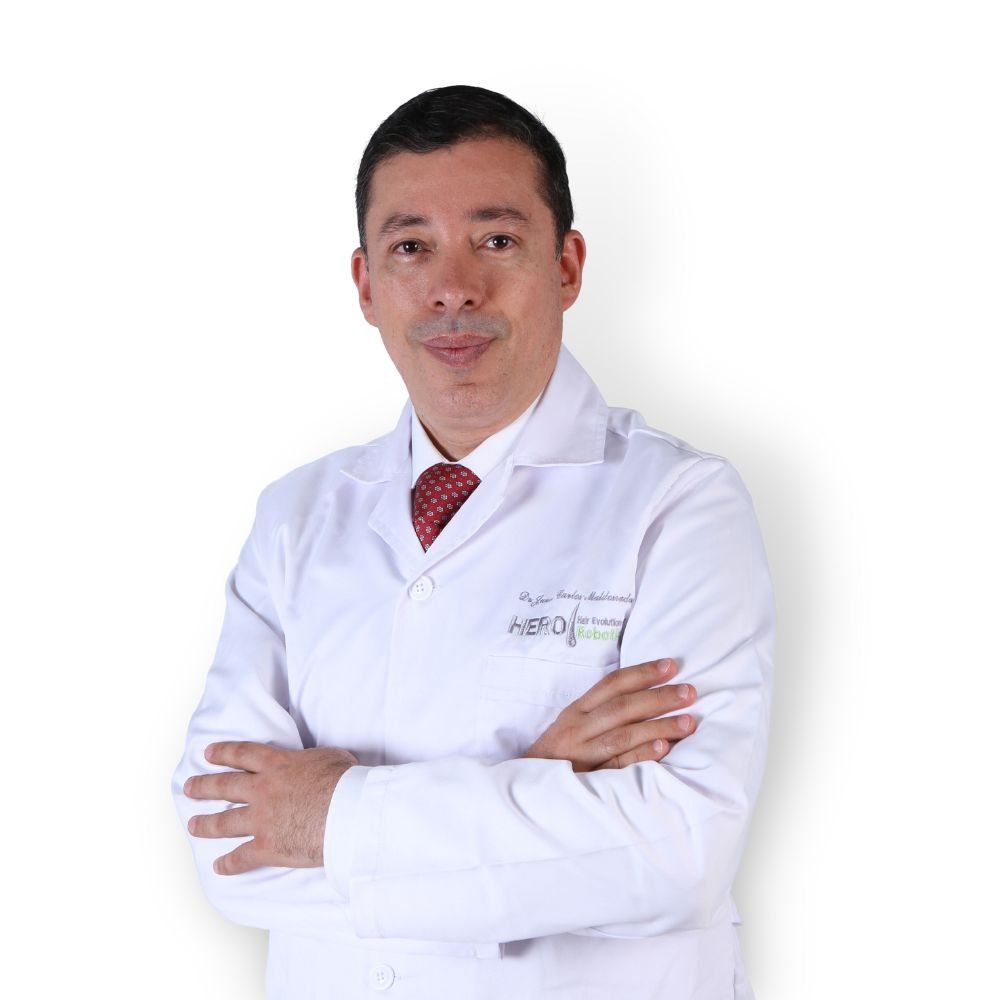 A man in a lab coat and tie with his arms crossed