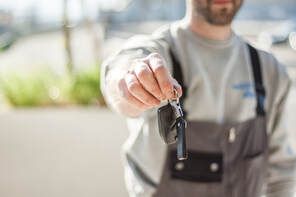 Burnaby Towing Worker handing over recover car keys that were locked in the vehicle.