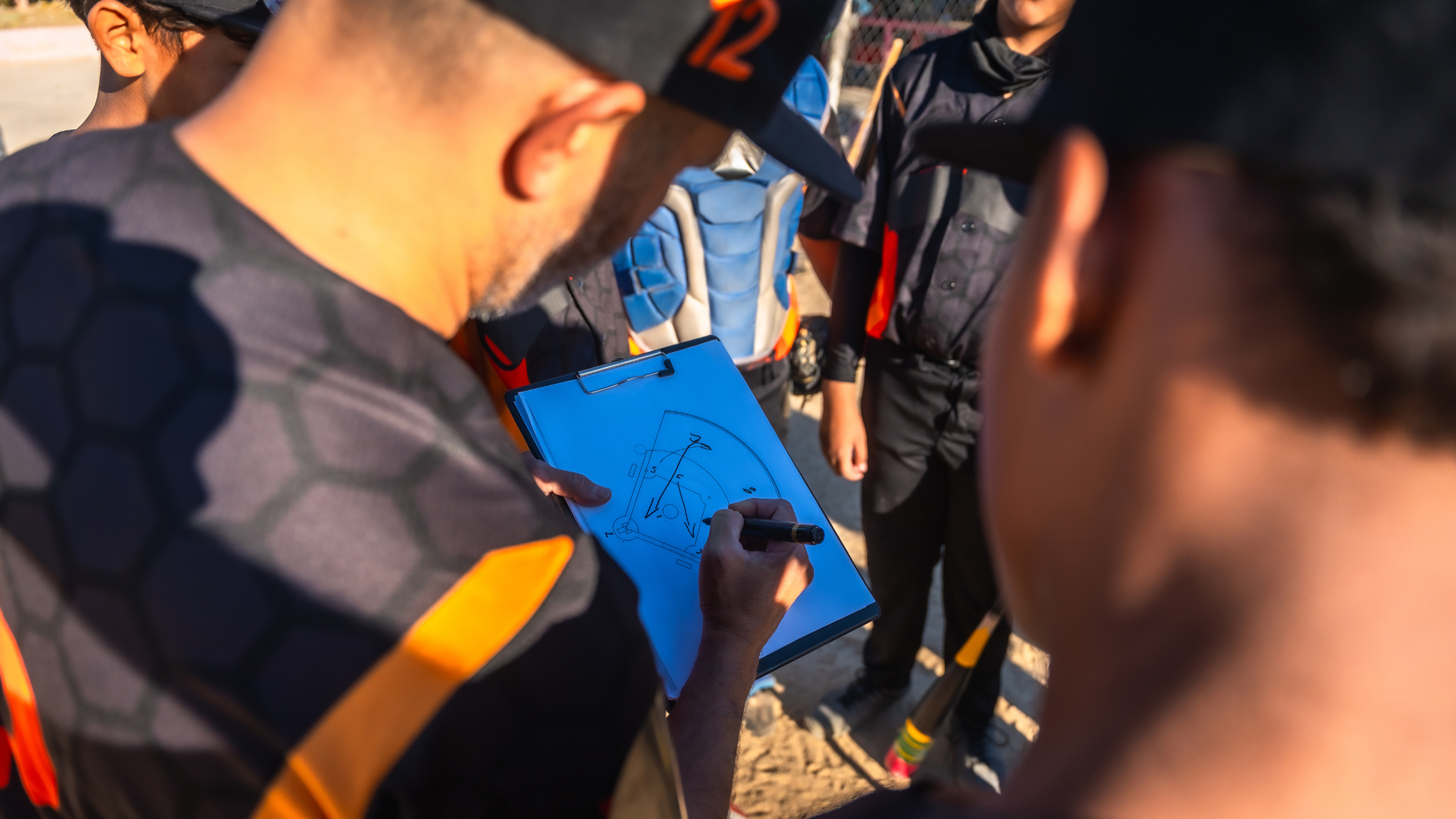 Cyclists gathered around a blue clipboard, reviewing notes before a ride