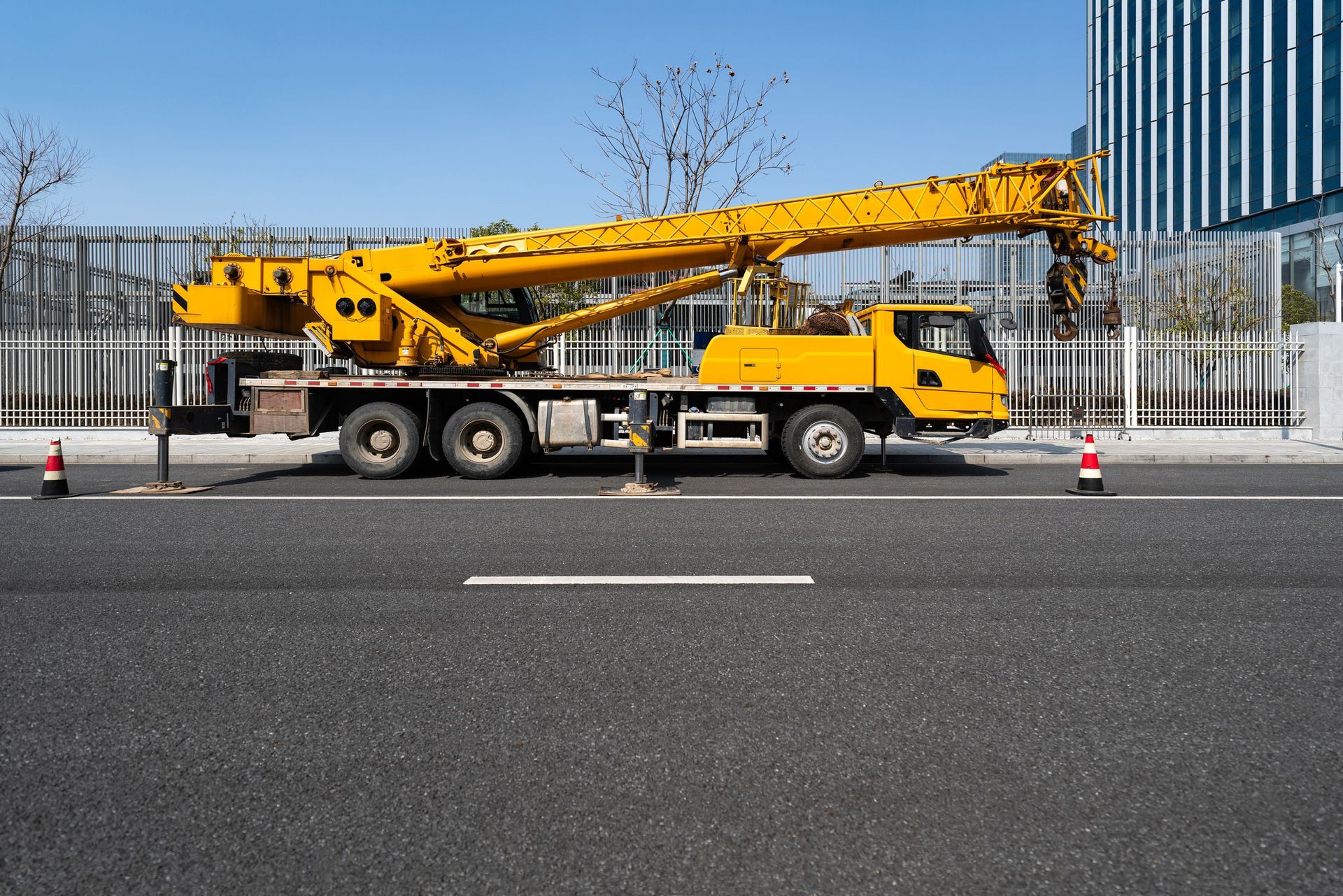 Yellow mobile crane on road