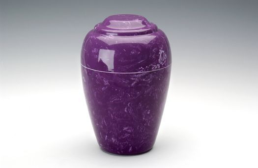 Purple ceramic urn with glossy finish on a white background
