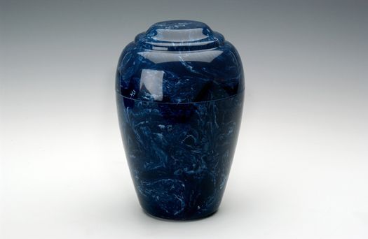 Dark blue decorative glass vase with a rounded, tapered shape on a white background