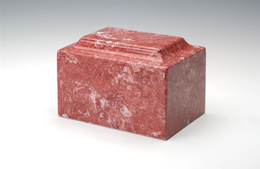 Red stone block with white marbling on a light background
