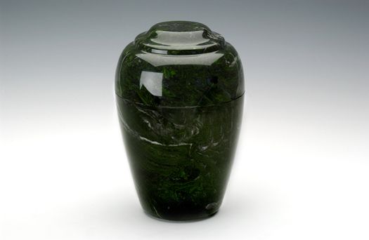 Dark green ceramic vase with a glossy finish on a white background