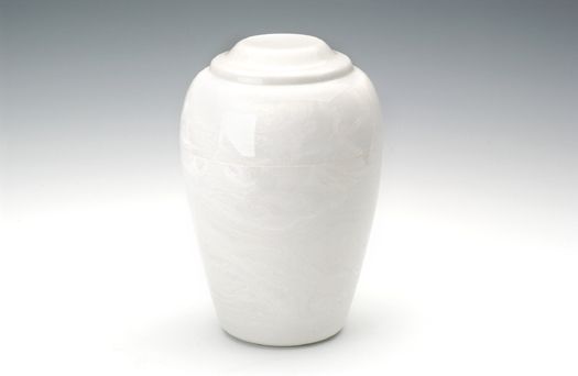 White ceramic lidded urn on a plain light background