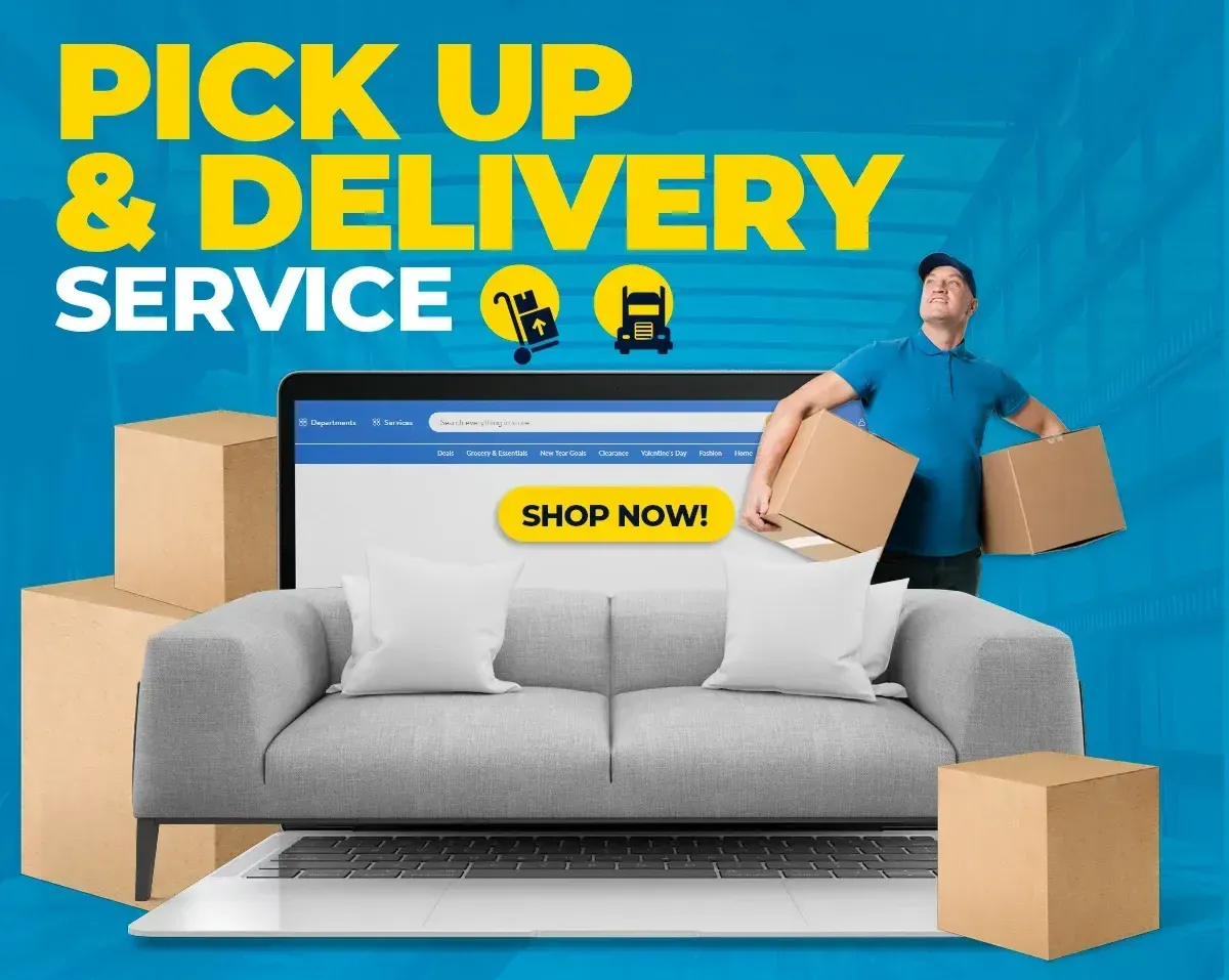 A man is holding a box in front of a laptop and a couch.