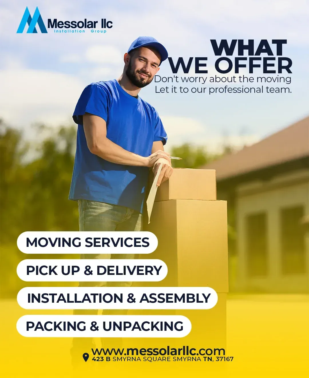 A man in a blue shirt is holding a cardboard box.