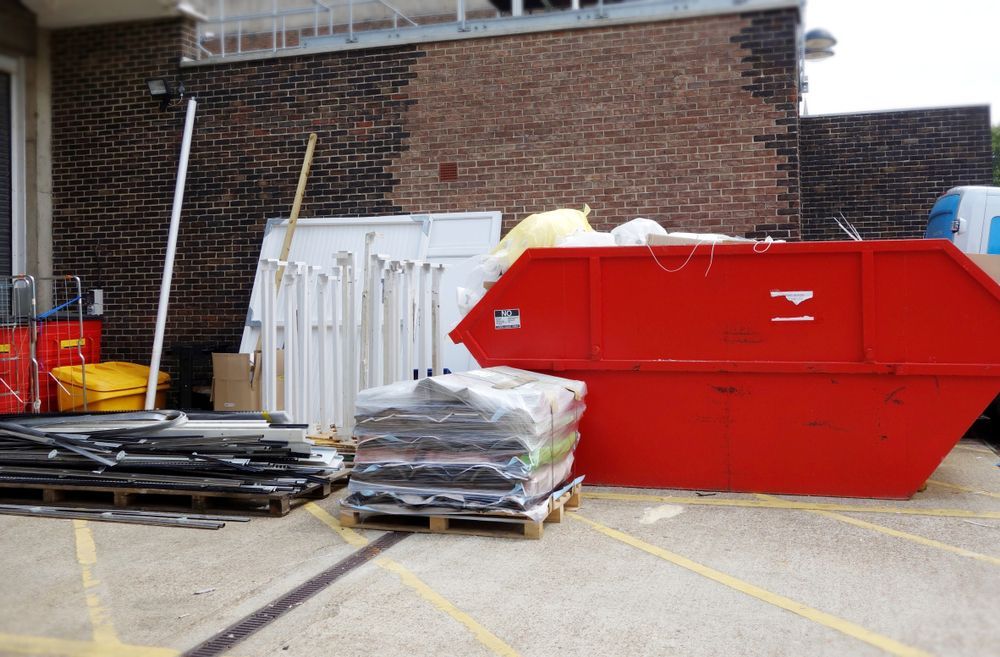 Red Hire Bin at the Back of the House — Alice Skip Hire in Alice Springs, NT