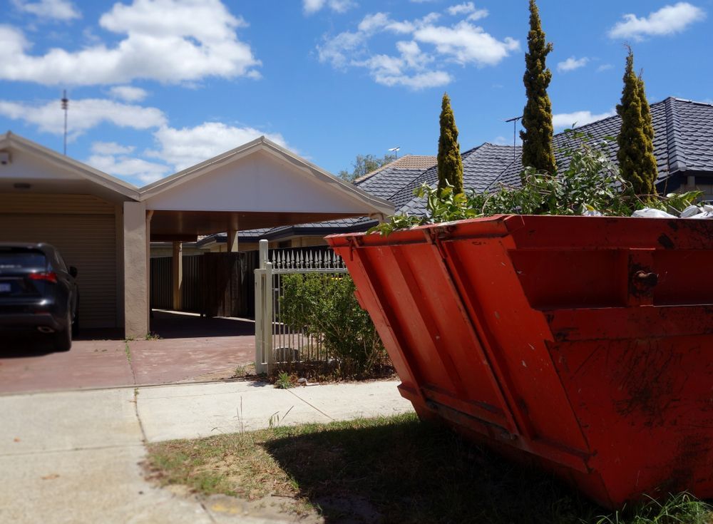 Red Hire Bin in Front of the House — Alice Skip Hire in Alice Springs, NT