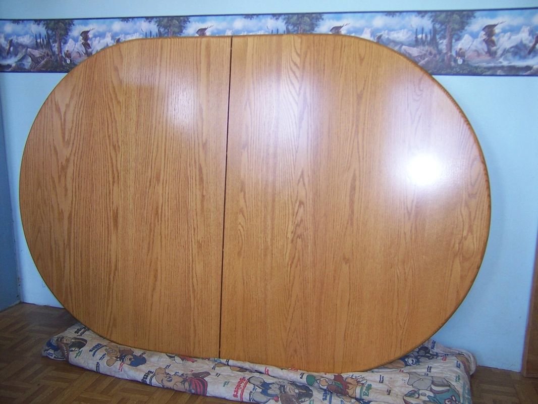 large kitchen table refinished and leaning against wall