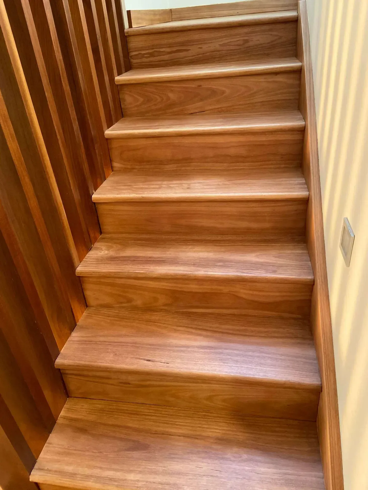 A Close Up of a Wooden Staircase With a Wooden Railing — Tweed Coast Cork & Timber Floors In Tweed Heads, NSW
