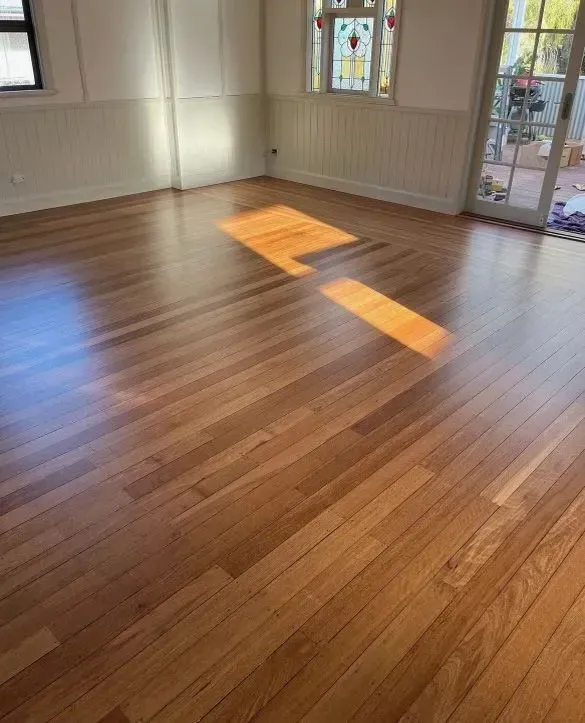 A Room With a Wooden Floor and a Stained Glass Window — Tweed Coast Cork & Timber Floors In Tweed Heads, NSW