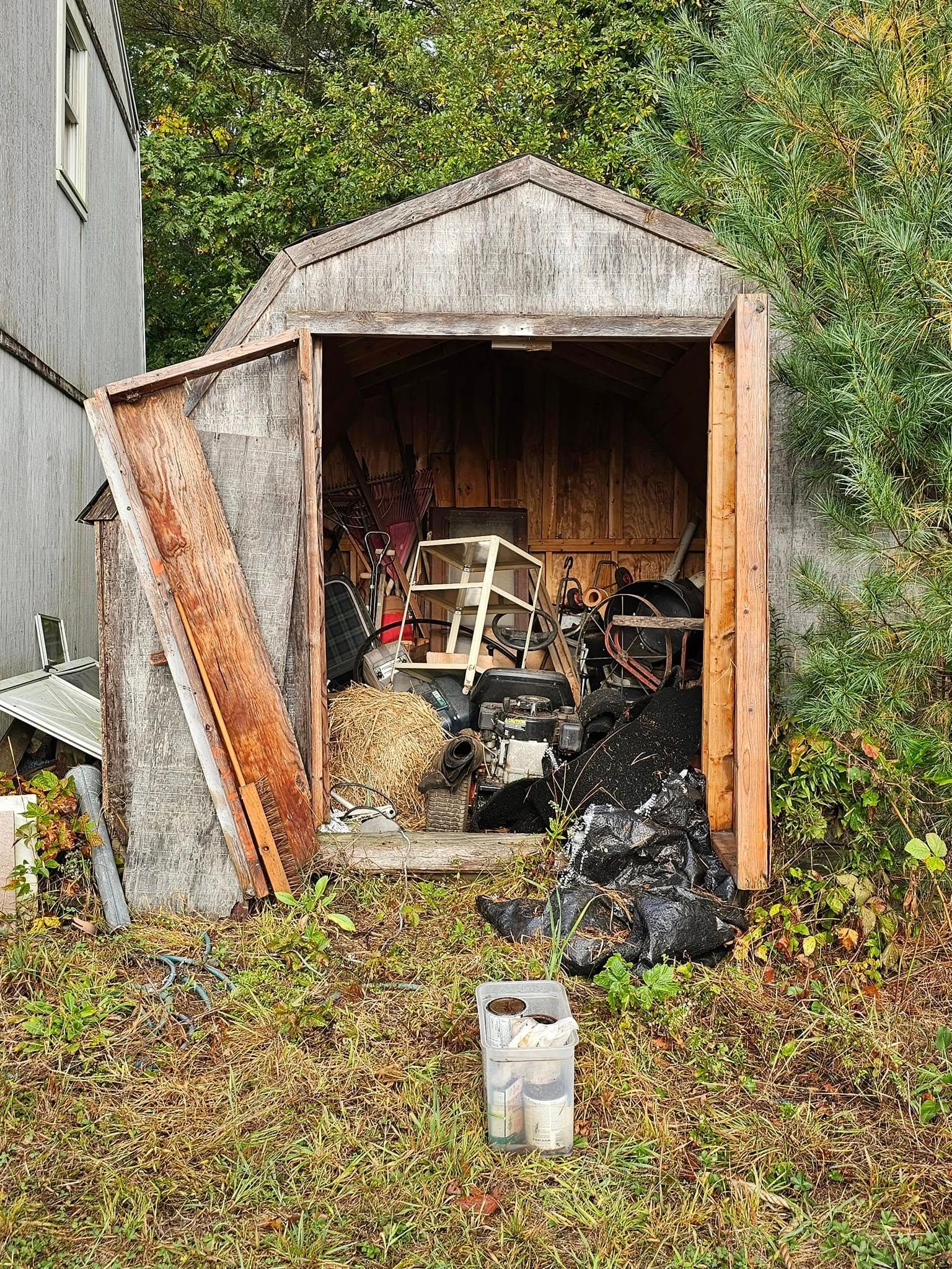 A shed is filled with lots of trash and junk.