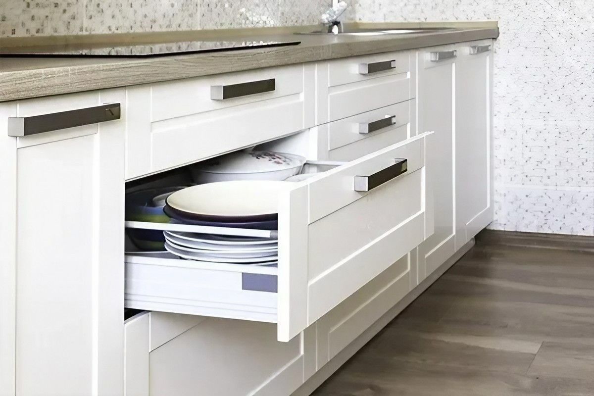 A Kitchen with White Cabinets and A Drawer Open with Plates in It — Bestbuy Kitchens in Yandina, QLD