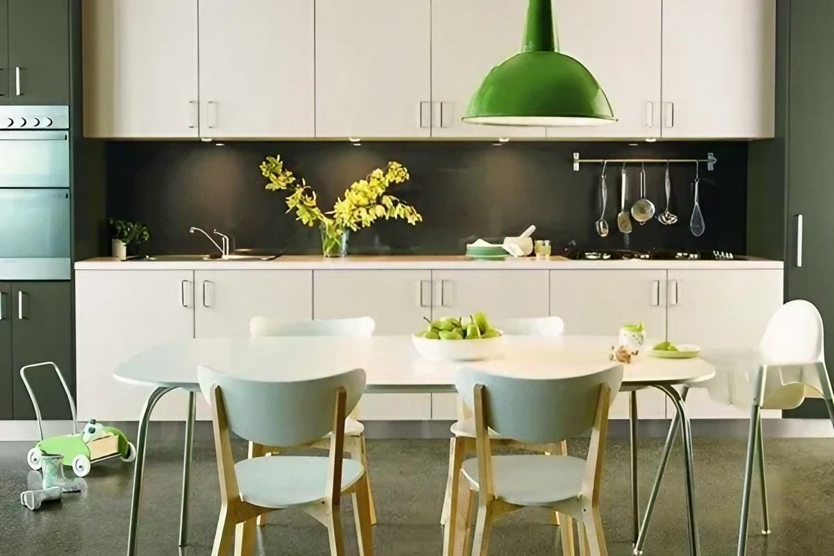 A Kitchen with A Table and Chairs and A Green Light — Bestbuy Kitchens in Yandina, QLD