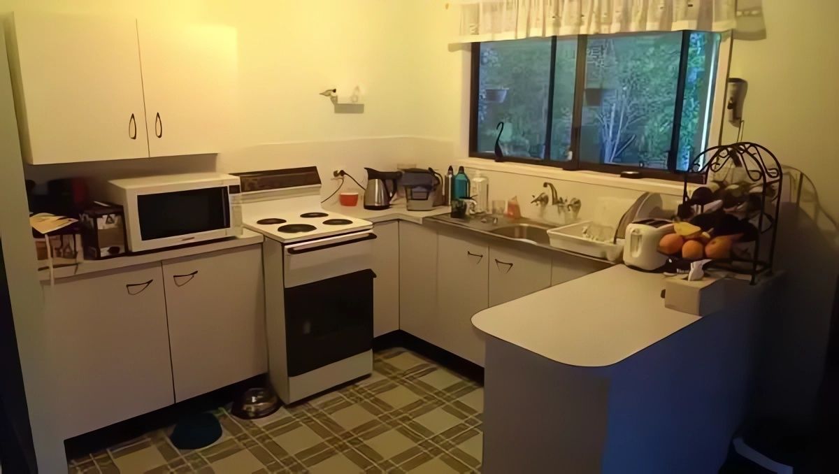 A Kitchen with A Stove, Microwave, Sink and Window — Bestbuy Kitchens in Yandina, QLD