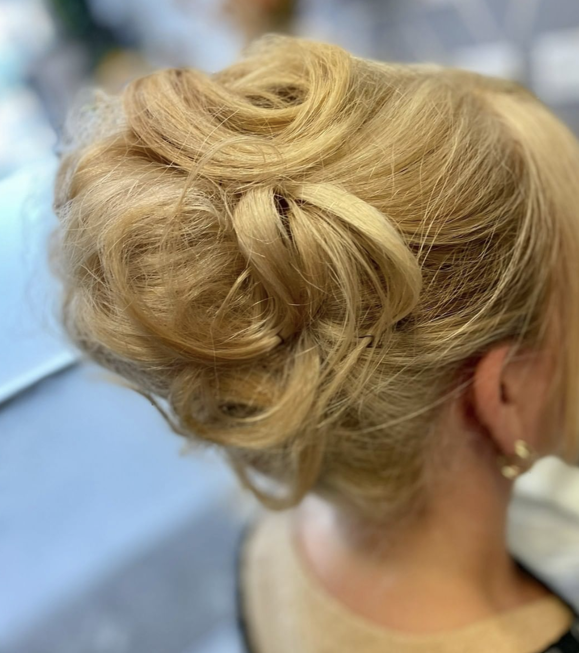 A close up of a woman 's hair in a bun.