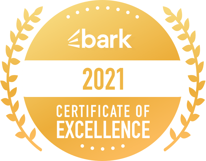 A gold badge that says bark certificate of excellence