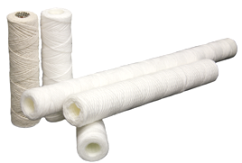 a group of string wound filters are stacked on top of each other on a white background .