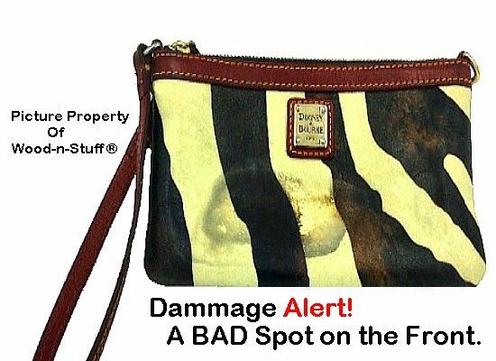 Zebra-striped Dooney & Bourke clutch with damage spot. Brown leather accents, wrist strap, and tag.