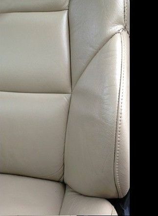 Beige leather car seat with visible stitching.