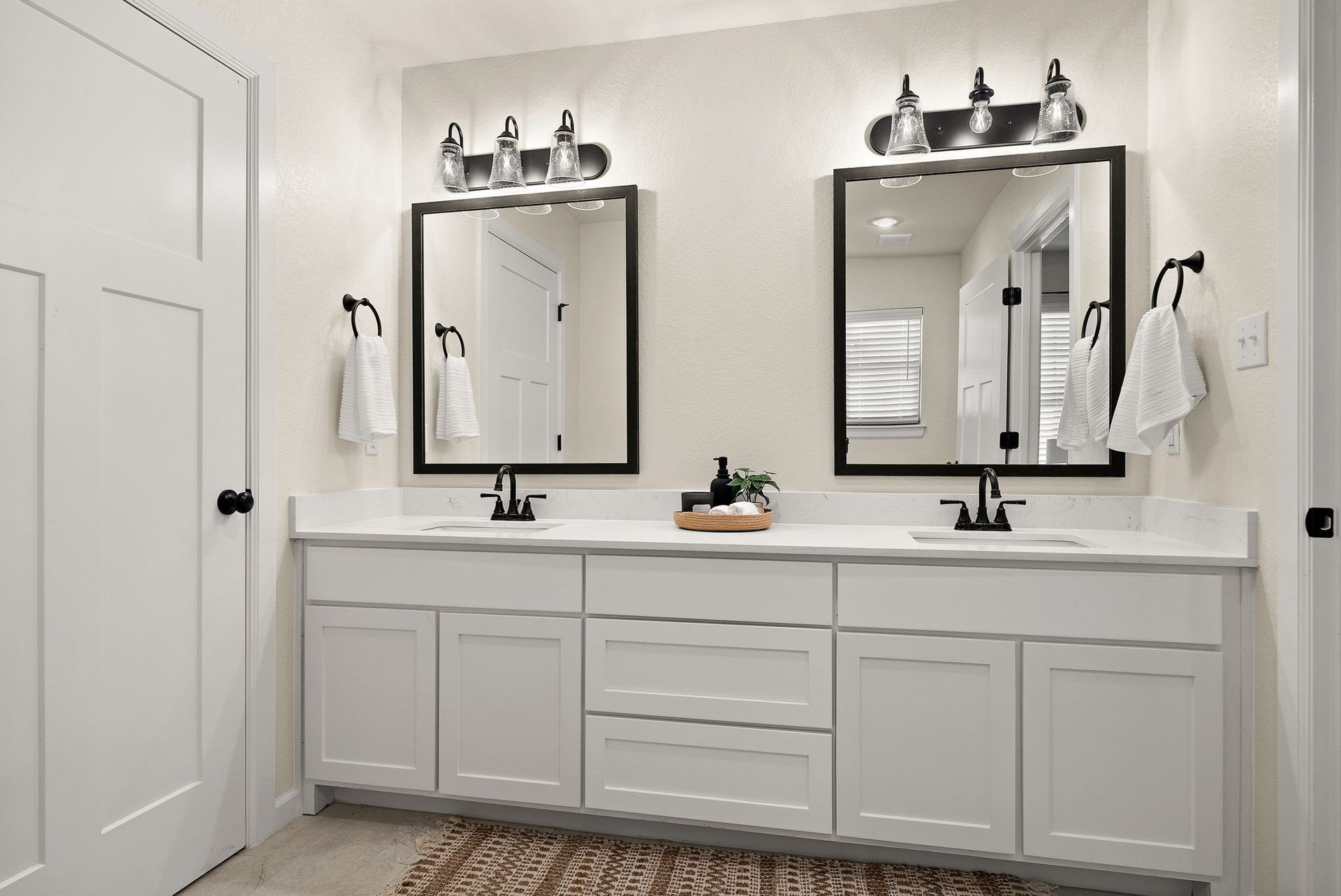 A bathroom with two sinks and two mirrors.