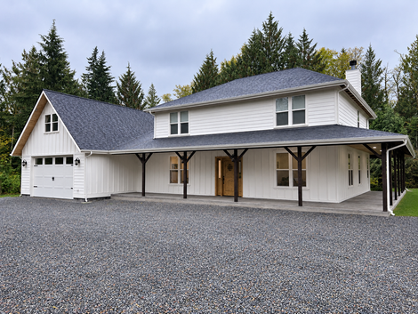 Newly-framed custom home under construction at golden hour