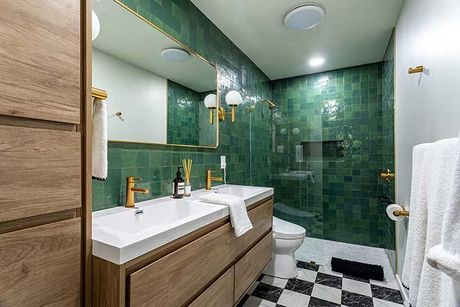 Modern bathroom interior with green tile walls