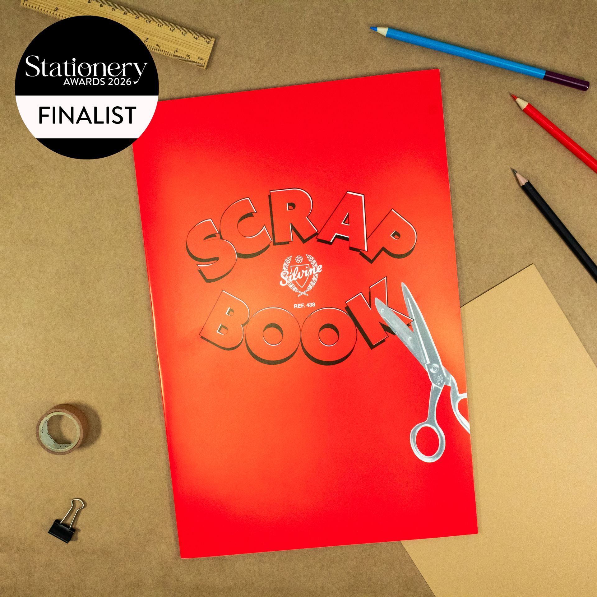 Red Classic Scrapbook on desk surrounded by stationery items. This image has the official 2026 Stationery Awards badge on it.