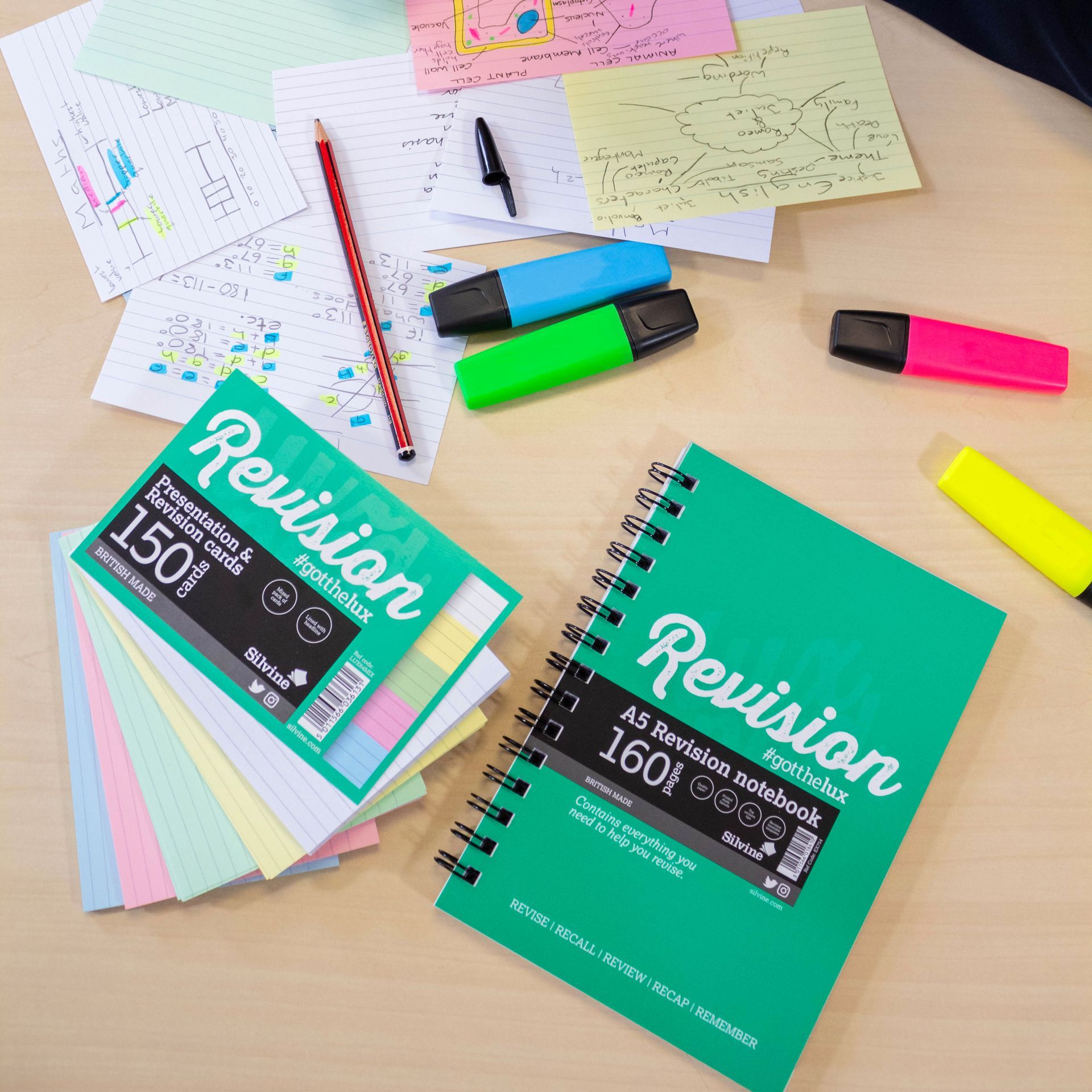 Revision cards and notebook on desk being used in school setting