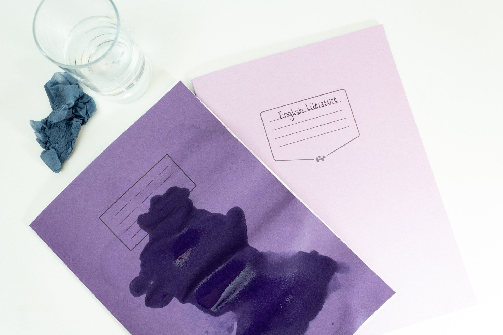 Tough Shall and normal exercise books having water spilled upon them.