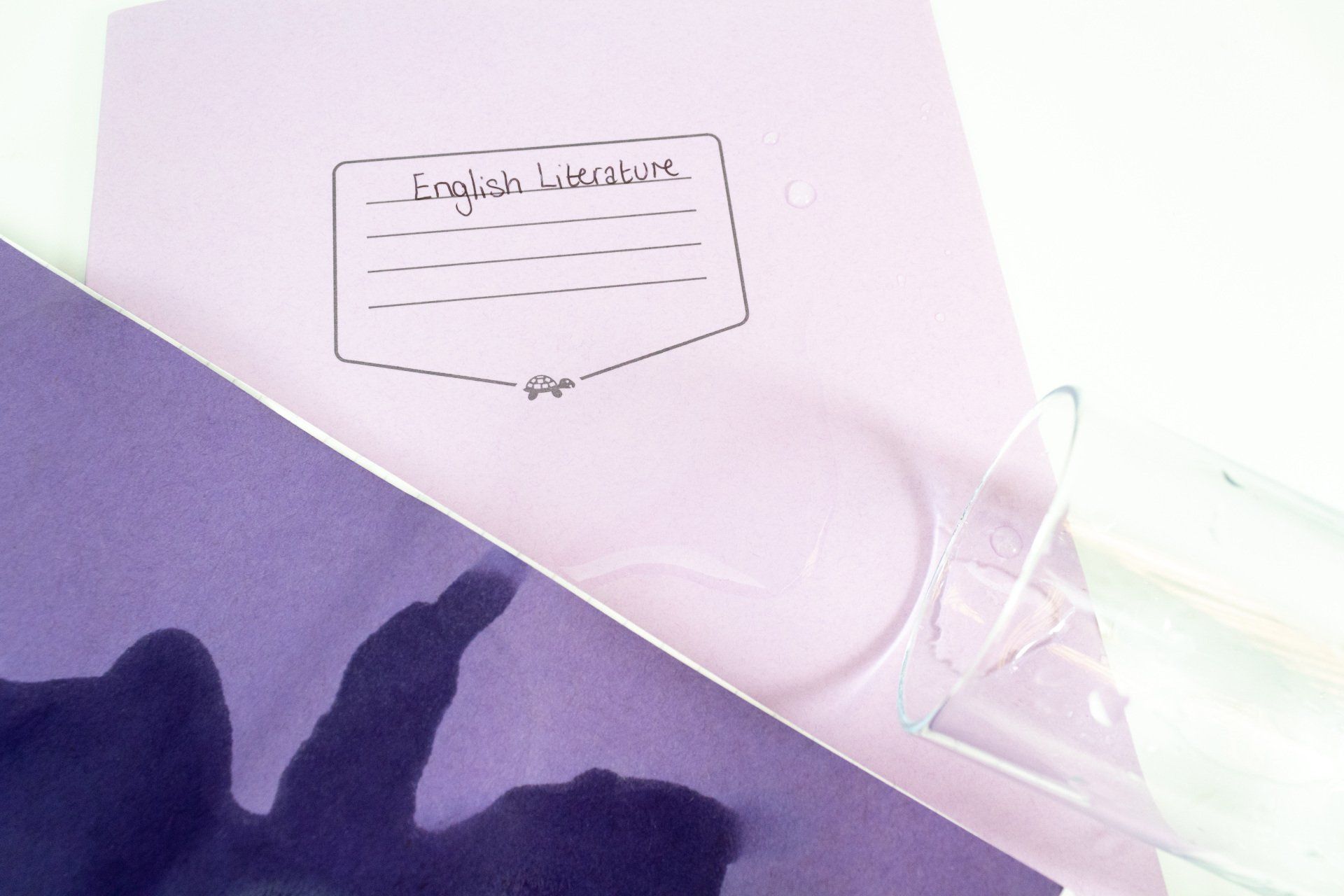 Tough Shall and normal exercise books having water spilled upon them.